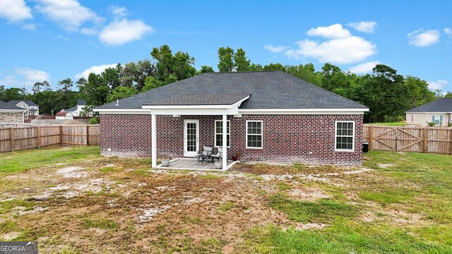 481 Akins Ranch Rd NE, Ludowici, GA 31316 - rear view of property with a lawn, brick siding, a fenced backyard, and roof with shingles