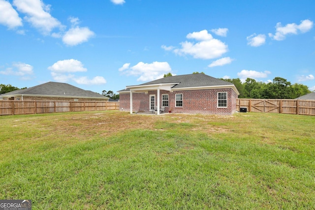 481 Akins Ranch Rd NE, Ludowici, GA 31316 - back of house featuring a fenced backyard, a lawn, and brick siding