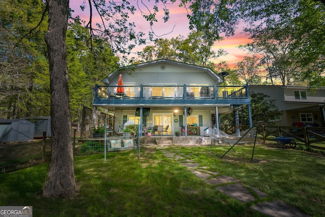 175 Mayo Rd, Covington, GA 30014 - back of house featuring a lawn, an outdoor structure, a shed, and a porch
