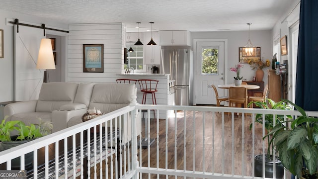 175 Mayo Rd, Covington, GA 30014 - living area featuring a barn door, a textured ceiling, and wood finished floors