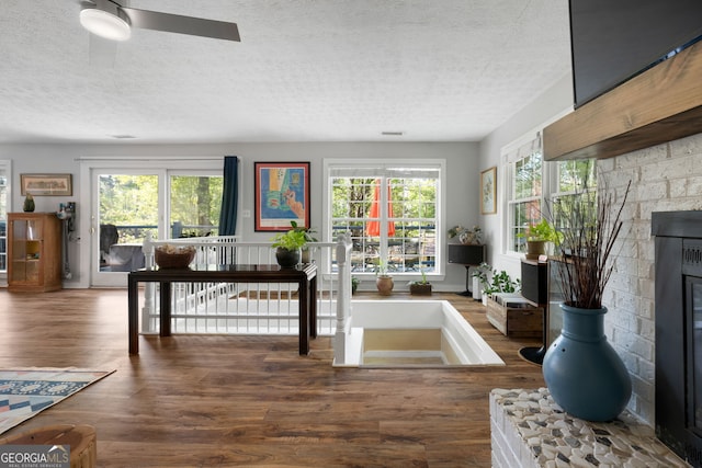 175 Mayo Rd, Covington, GA 30014 - interior space with a textured ceiling, ceiling fan, wood finished floors, and a fireplace