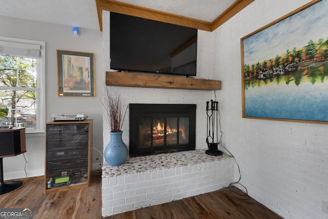 175 Mayo Rd, Covington, GA 30014 - details featuring a textured ceiling, a brick fireplace, and wood finished floors
