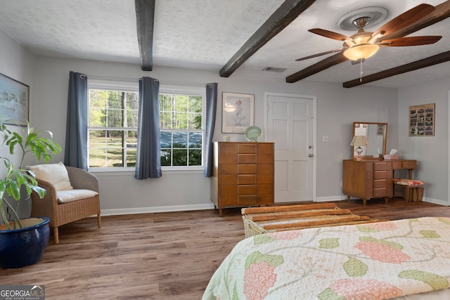 175 Mayo Rd, Covington, GA 30014 - bedroom with visible vents, baseboards, wood finished floors, and beamed ceiling