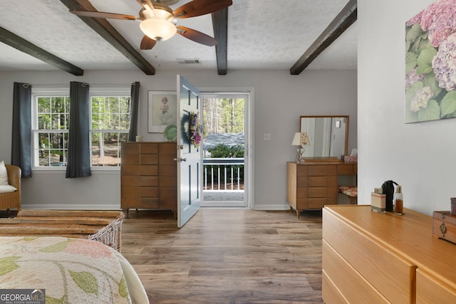 175 Mayo Rd, Covington, GA 30014 - bedroom with multiple windows, access to exterior, wood finished floors, beamed ceiling, and visible vents