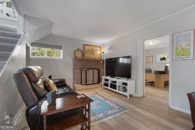 175 Mayo Rd, Covington, GA 30014 - living area featuring a brick fireplace, baseboards, stairs, and light wood finished floors