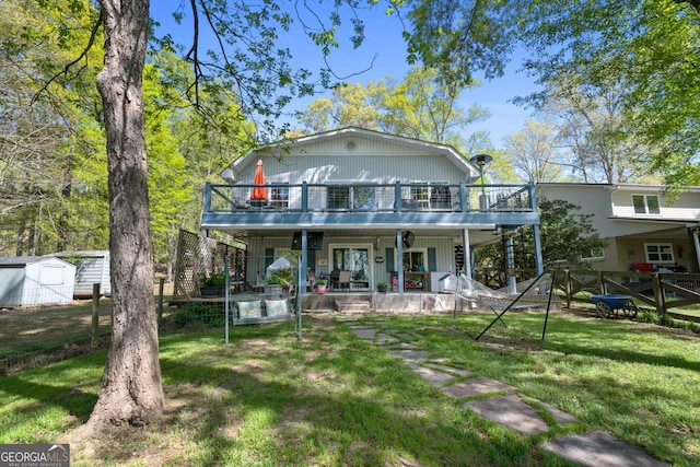 175 Mayo Rd, Covington, GA 30014 - rear view of property with fence, a storage unit, a deck, an outbuilding, and a yard