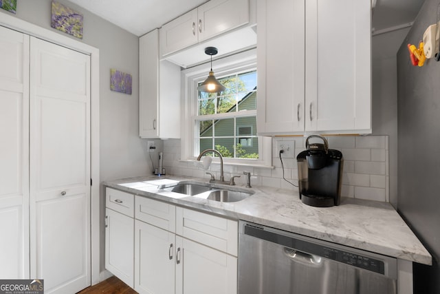 175 Mayo Rd, Covington, GA 30014 - kitchen featuring stainless steel dishwasher, decorative backsplash, white cabinetry, light stone counters, and a sink