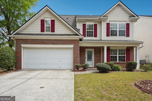 traditional home featuring brick siding, a shingled roof, a front lawn, and driveway