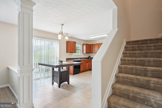 stairs featuring ornate columns, a textured ceiling, baseboards, and an inviting chandelier