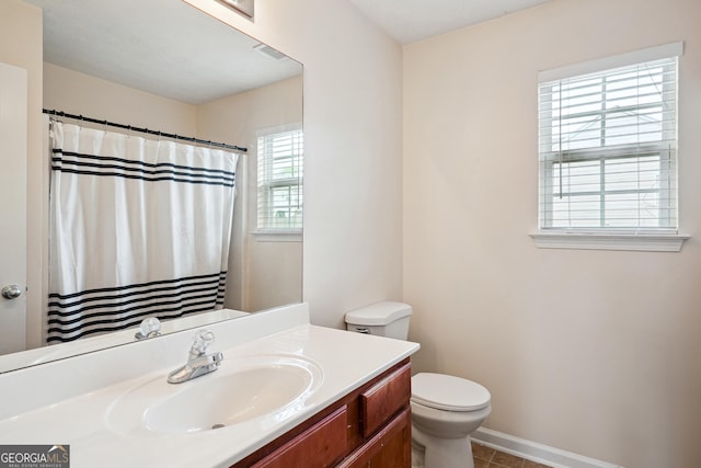 bathroom with vanity, toilet, baseboards, a shower with curtain, and visible vents