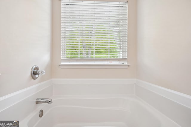 full bathroom with plenty of natural light and a garden tub