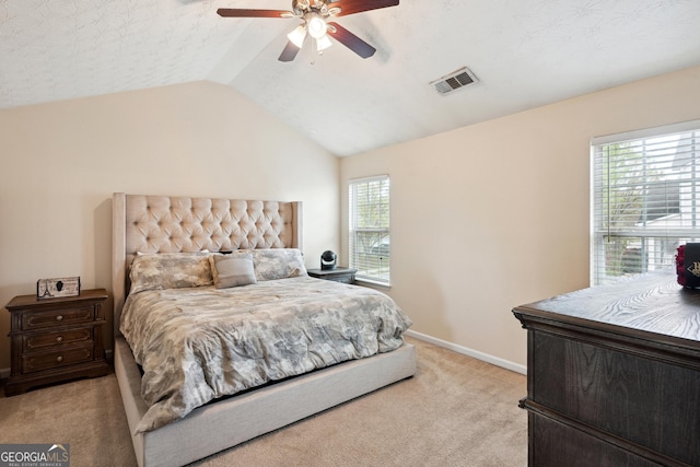 bedroom with ceiling fan, light carpet, baseboards, lofted ceiling, and visible vents