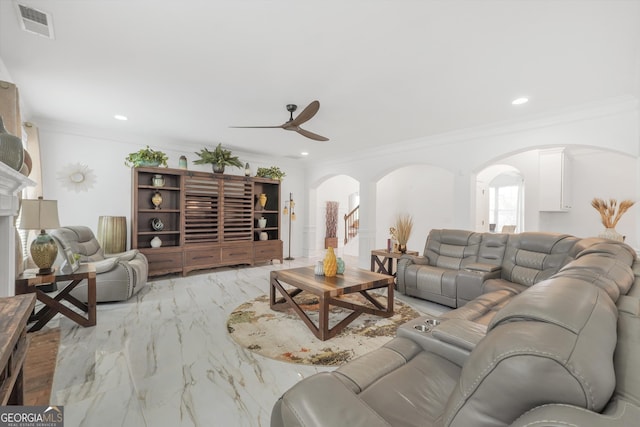 living area with a ceiling fan, crown molding, arched walkways, marble finish floor, and recessed lighting