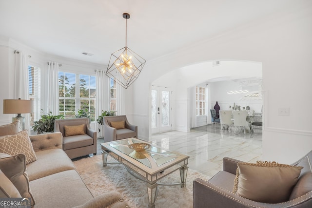 living area featuring crown molding, an inviting chandelier, arched walkways, marble finish floor, and visible vents
