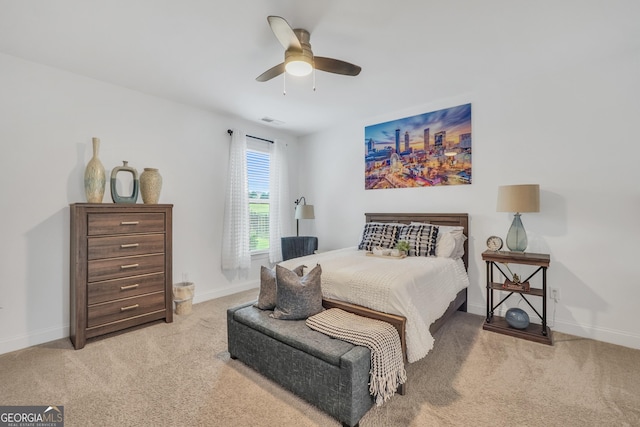 carpeted bedroom with a ceiling fan, baseboards, and visible vents