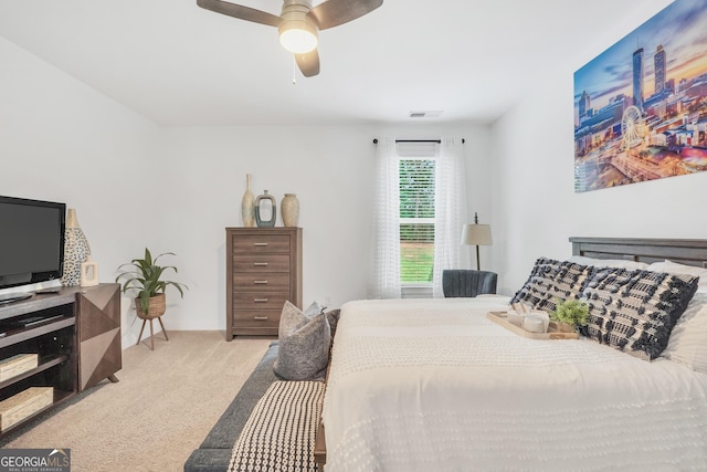 bedroom with baseboards, ceiling fan, light carpet, and visible vents
