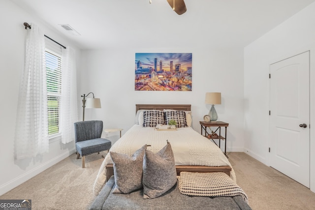 bedroom with carpet floors, baseboards, a ceiling fan, and visible vents