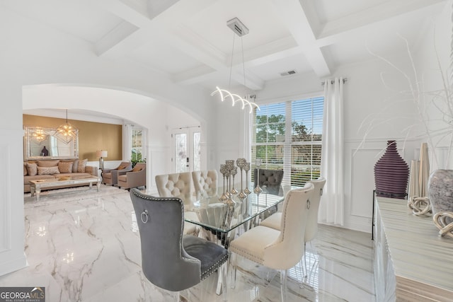 dining room featuring arched walkways, a chandelier, marble finish floor, and coffered ceiling
