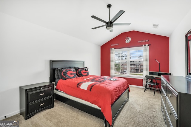 bedroom with ceiling fan, light colored carpet, visible vents, baseboards, and vaulted ceiling