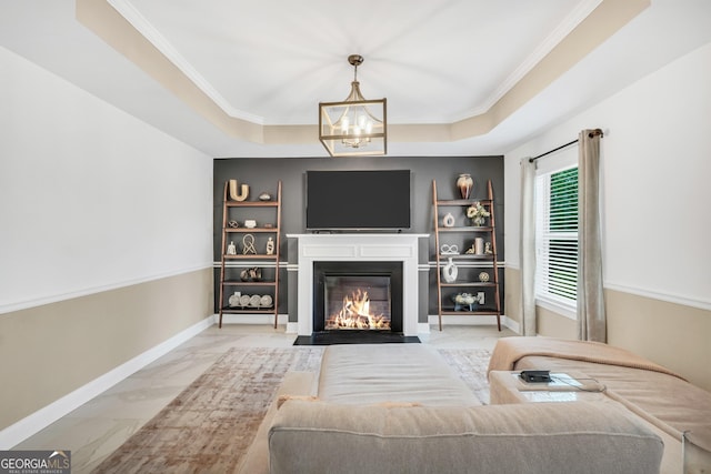 living area featuring crown molding, an inviting chandelier, marble finish floor, baseboards, and a fireplace with flush hearth