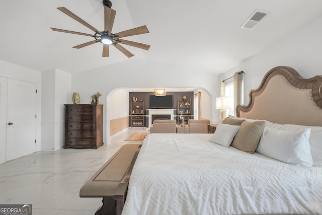 bedroom with visible vents, a ceiling fan, marble finish floor, lofted ceiling, and arched walkways