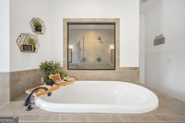full bathroom featuring a shower stall and a garden tub