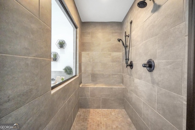 full bathroom featuring a tile shower