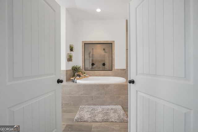 full bath with a garden tub and a shower