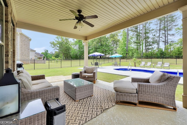 view of patio / terrace featuring a fenced backyard, a fenced in pool, ceiling fan, and an outdoor living space