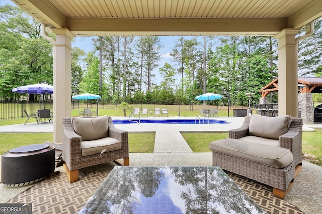 view of patio / terrace featuring a fenced in pool, a fenced backyard, outdoor lounge area, and outdoor dining space
