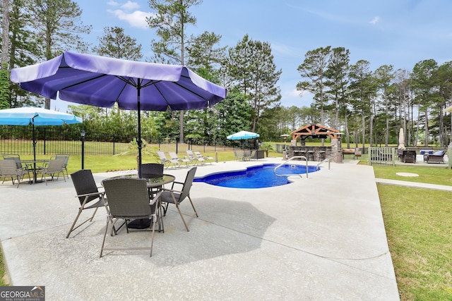 view of swimming pool featuring fence, a patio, a fenced in pool, a gazebo, and a yard