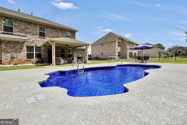 view of pool with a fenced in pool, a ceiling fan, a fenced backyard, and a patio area