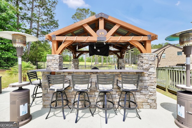 view of patio / terrace with a gazebo, fence, and outdoor dry bar