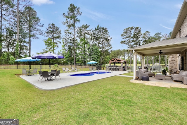 view of yard with a ceiling fan, a gazebo, a patio area, and outdoor lounge area