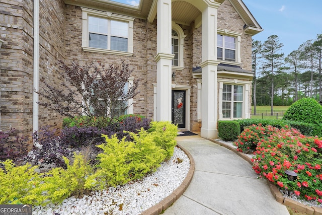 entrance to property featuring brick siding