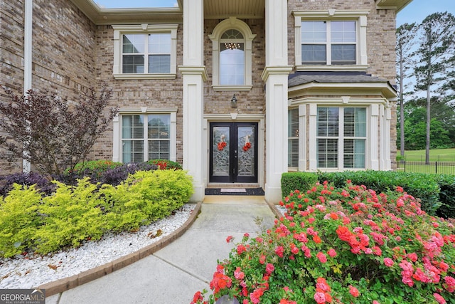 doorway to property with brick siding and french doors