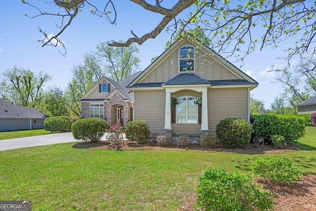 4577 San Saba Dr, Hahira, GA 31632 - view of front of property with board and batten siding, stone siding, concrete driveway, and a front yard