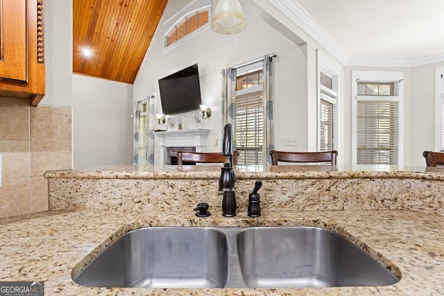 4577 San Saba Dr, Hahira, GA 31632 - kitchen featuring light stone countertops, a sink, a fireplace, wooden ceiling, and lofted ceiling