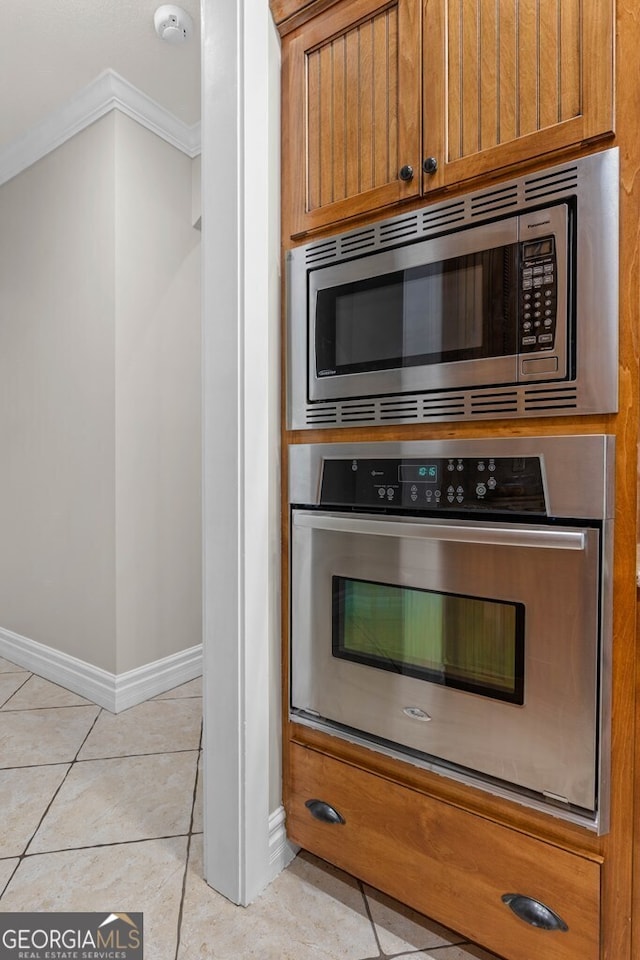 4577 San Saba Dr, Hahira, GA 31632 - kitchen featuring baseboards, ornamental molding, appliances with stainless steel finishes, and light tile patterned floors
