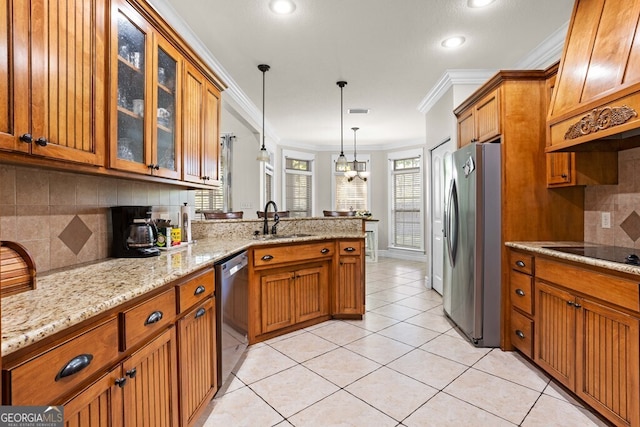 4577 San Saba Dr, Hahira, GA 31632 - kitchen featuring brown cabinets, stainless steel appliances, a sink, and a peninsula