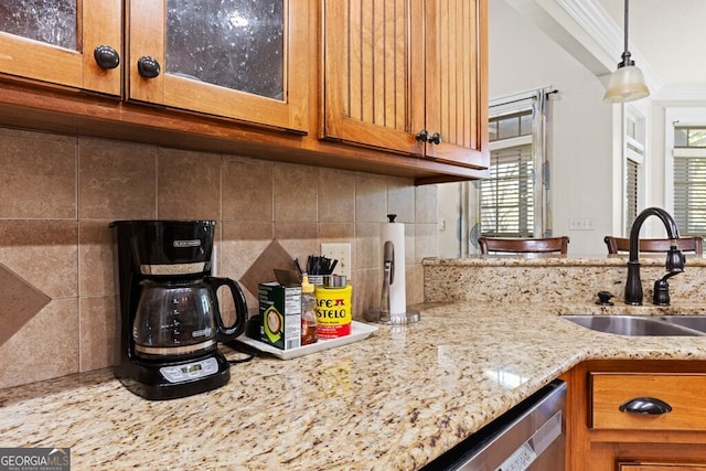 4577 San Saba Dr, Hahira, GA 31632 - kitchen with brown cabinets, plenty of natural light, a sink, and tasteful backsplash