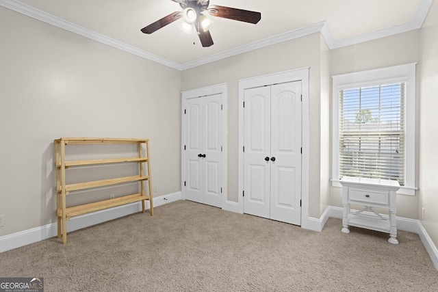 4577 San Saba Dr, Hahira, GA 31632 - unfurnished bedroom featuring multiple closets, ornamental molding, and carpet floors