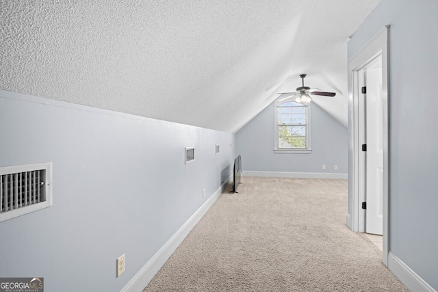 4577 San Saba Dr, Hahira, GA 31632 - bonus room with ceiling fan, a textured ceiling, visible vents, vaulted ceiling, and carpet