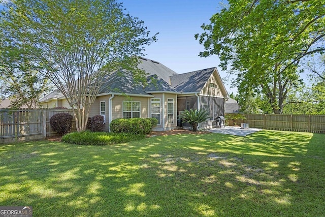 4577 San Saba Dr, Hahira, GA 31632 - view of front of house featuring a fenced backyard, roof with shingles, a patio, and a front lawn
