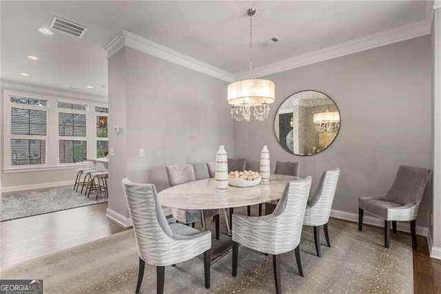 3592 Parkhaven Pl, Brookhaven, GA 30319 - dining room featuring visible vents, crown molding, wood finished floors, baseboards, and a chandelier