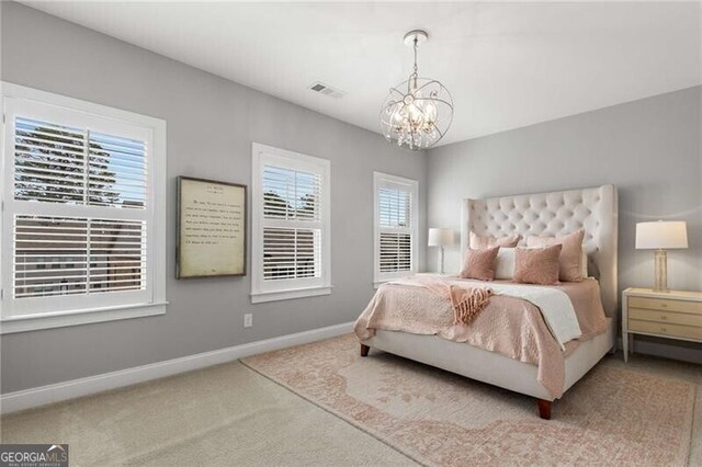 3592 Parkhaven Pl, Brookhaven, GA 30319 - carpeted bedroom featuring a notable chandelier, visible vents, and baseboards