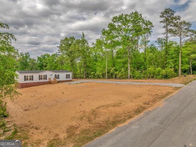 view of property's community with a wooded view