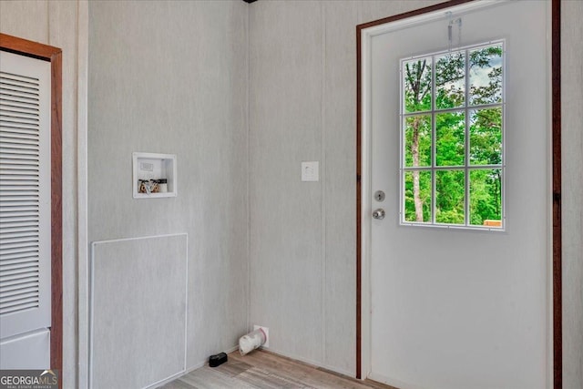 laundry room featuring light wood-style floors, laundry area, hookup for a washing machine, and a heating unit