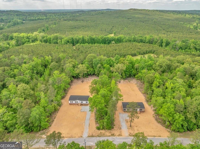 drone / aerial view featuring a wooded view