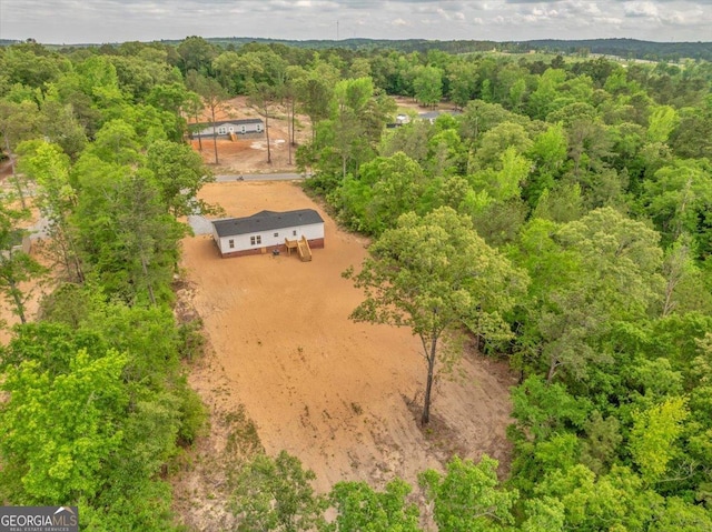 birds eye view of property with a forest view